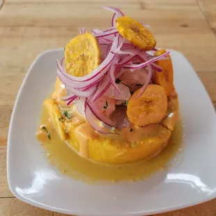 a plate of food on a wooden table