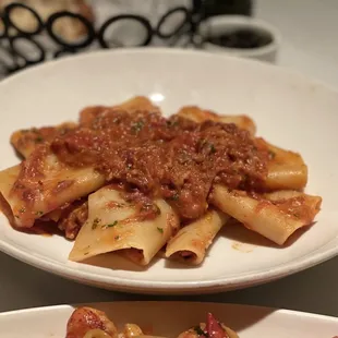 two plates of pasta with sauce