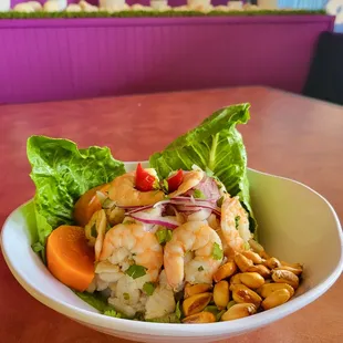 a shrimp salad with lettuce, carrots, and peanuts
