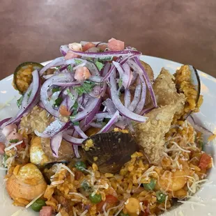 Arroz con Mariscos (rice with seafood) has fried calamari, fried shrimp, non-fried shrimp, clams, mussels, and more with an incredible rice