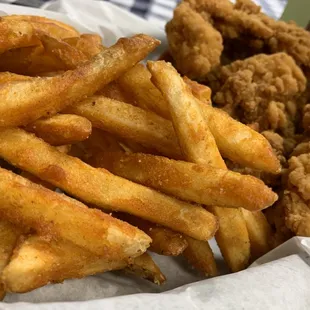 a basket of fried chicken and french fries