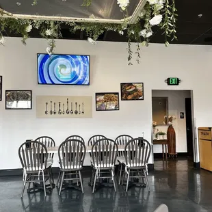 a long table with chairs and a television