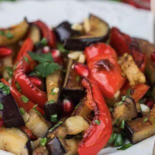 a plate of grilled vegetables with a fork