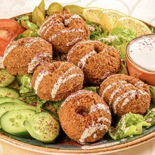 a plate of fried donuts and vegetables