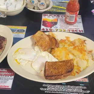 Breakfast combo with sausage, 2 over easy eggs, homefries, and toast