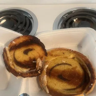 two pastries in a styrofoam container