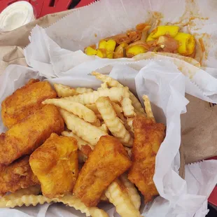 Fried cod meal that comes with fries and sauteed peppers and onions and tarter sauce