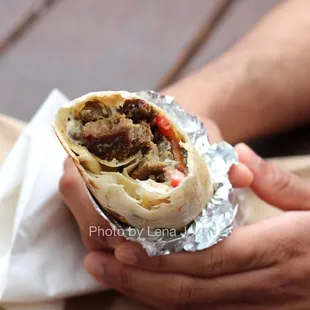 11 A. Lamb and beef shawarma sandwich ($9.55) - Grilled lamb and beef in a 12&quot; crispy rolled pita with grilled onions and tomato