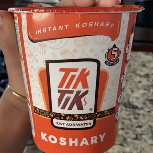 a hand holding a cup of ice cream