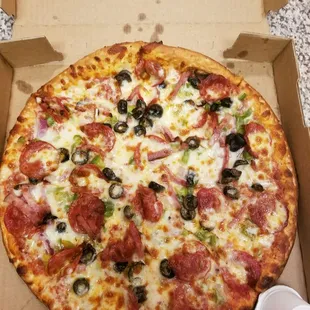Pepperoni green peppers onions and olives.. look at how good it looks! This is why I love this place..