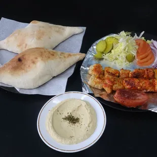 Chicken Kebab Platter served with bread and hummus.