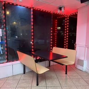 a table and chairs in front of a window