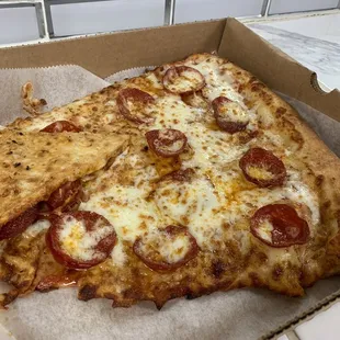 Jumbo slice, folded to fit into the personal sized pizza box