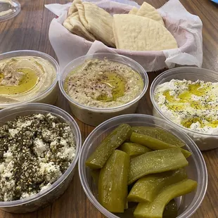Mezze plate with hummus, baba ganoush, labneh, feta, and pickles