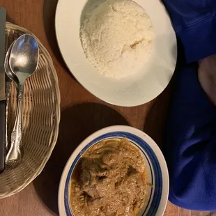 a bowl of stew and a plate of rice