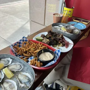 Happy hour oysters, fries, fried goat