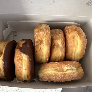 Half a dozen donuts; 2 chocolate-raised, 2 maple-raised, and 2 sugar-raised  $1.50 each, $10 for 1/2 dozen, or $19 for a dozen