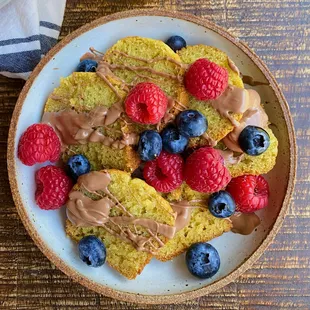 Blood Orange Olive Oil Cake with a drizzle of chocolate and some fresh berries