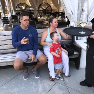 a family sitting on a bench