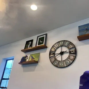 Photo wall of original wine branding art done by owner's family.