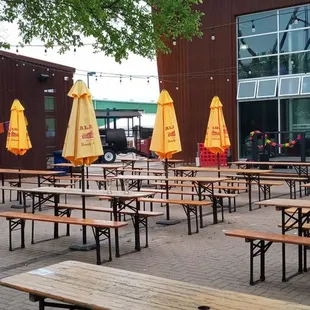 Outdoor seating, stage and in the back is the brewery..