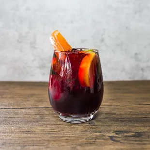 a glass of sangico with orange slices