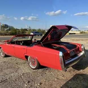 a red car with its hood open