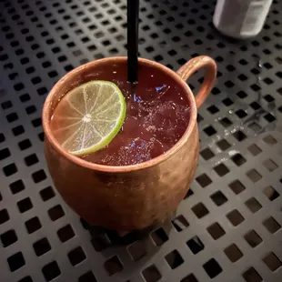 a drink in a copper mug with a lime slice