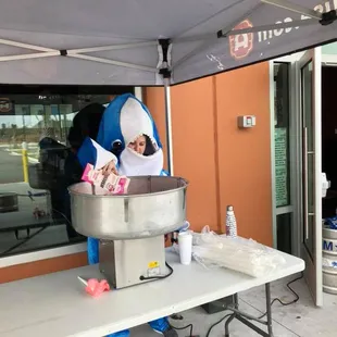 Passing out free cotton candy at our First Anniversary Party
