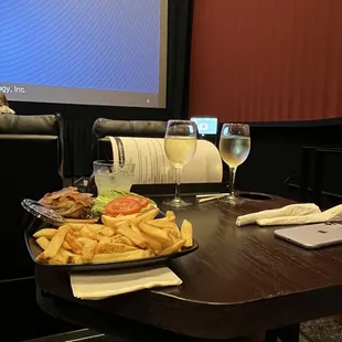 a plate of fries and a glass of wine