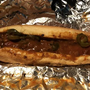 Baconless hotdog with chili and jalapeño toppings