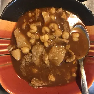 a bowl of stew with a spoon