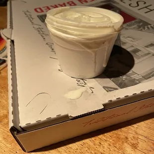 a cup of yogurt on top of a book