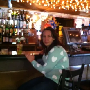 a woman sitting at a bar