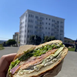 a hand holding a sandwich