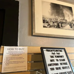 Framed artwork by local artists for sale displayed on their wall