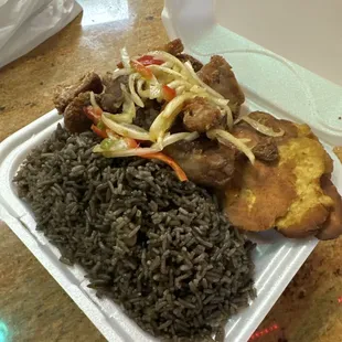 Jon Jon rice with Griot Dinner and fried Plantains