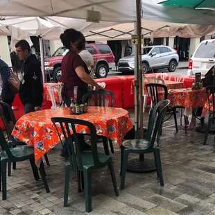 Outdoor seating in front of the restaur on both the sidewalk and the Parklet