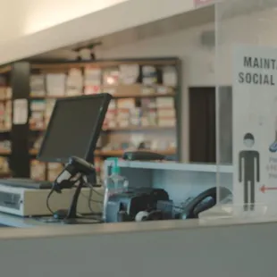 Cash register and social distancing sign at Alan's Shoes Speedway