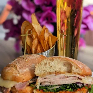Roast Pork Sandwich stacked high with herb-roasted pork loin, romesco, arugula, red onion, and Manchego on toasted ciabatta.