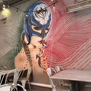 a woman's face painted on a wall