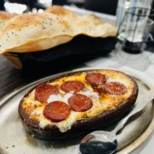 The AMAZING signature hummus with mozzarella cheese and sausage