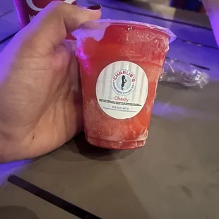 a hand holding a drink