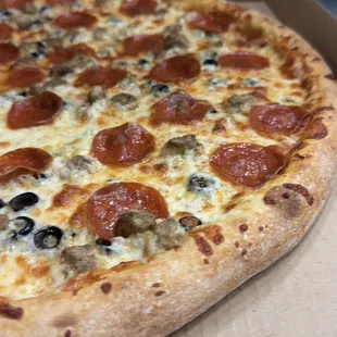 Our Deluxe Pizza is a mouthwatering combination of classic toppings - pepperoni, sausage, black olives, salami, and mushrooms.
