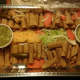 36 pieces rolled tacos half beef and half  chicken cheese guacamole spicy and one not spicy and lettuce it comes with salsas too.