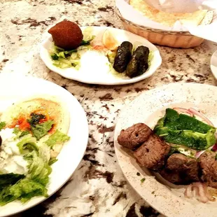 Albasha platter; grape leaves, beef kabob, hummus, feta salad and kibbi