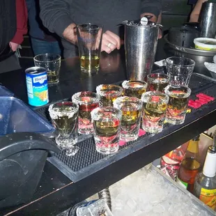 a bar with several glasses of alcohol