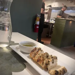 Bread with rosemary topping and olive oil with a splash of balsamic vinegar
