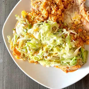 Chicken Enchilada (2) Plate. Topped with lettuce &amp; cheese. Comes with delicious refried beans &amp; fluffy rice. Love this dish!