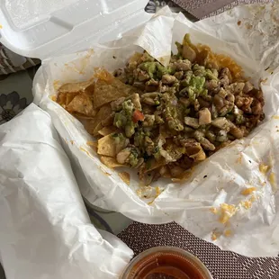 Pollo asado nachos and wrapped pollo asado taco